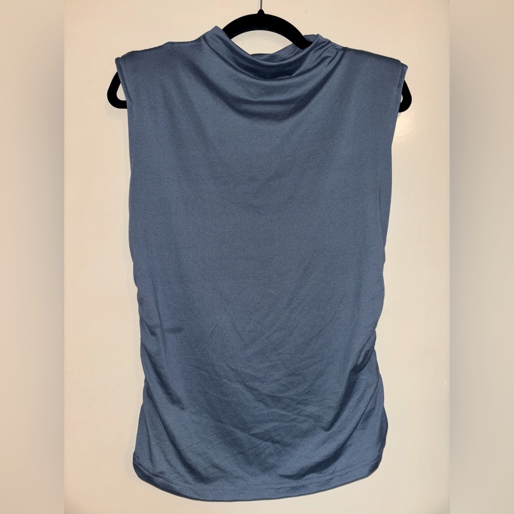 Soft women’s blouse with mock neck, shoulder pads, rouched sides